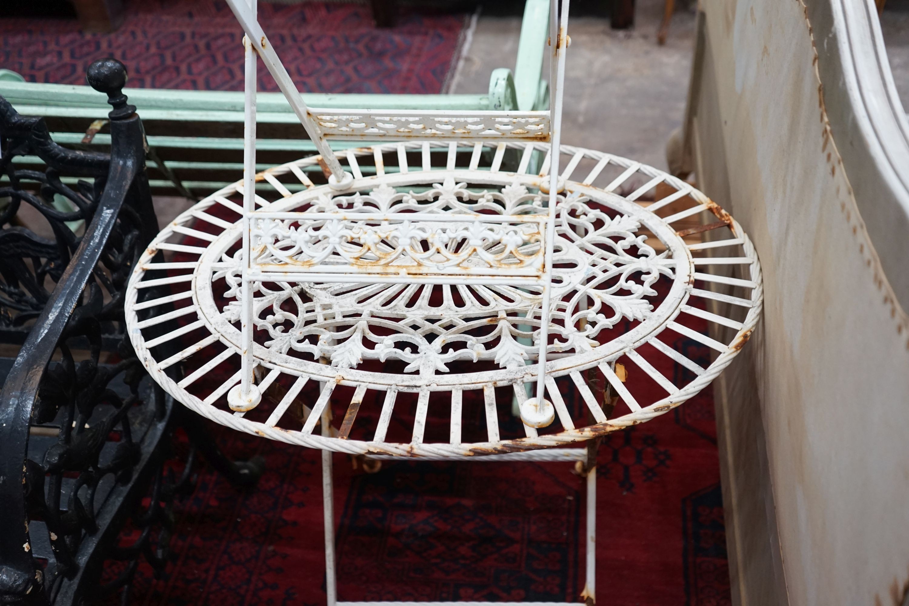 An oval painted metal folding garden table, length 74cm, depth 56cm, height 69cm and a chair